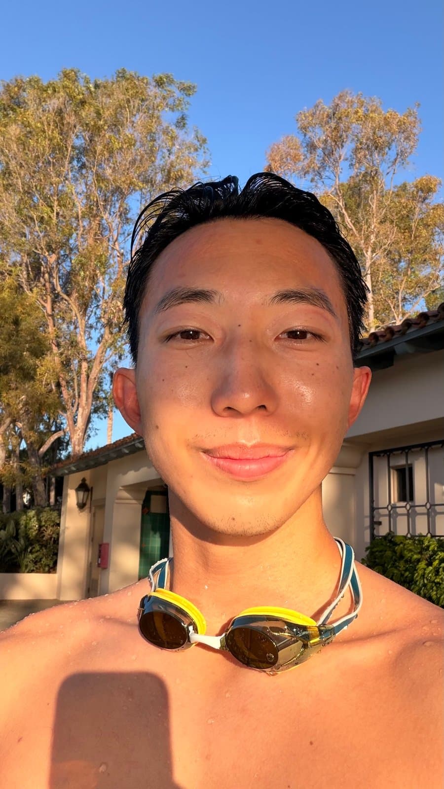 Poolside after the swim, goggles around my neck