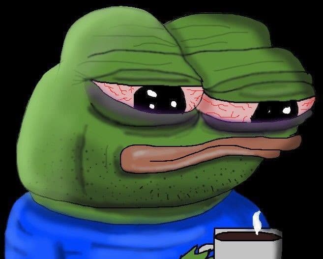 Pepe the Frog with bloodshot eyes sitting slumped over a steaming cup of coffee